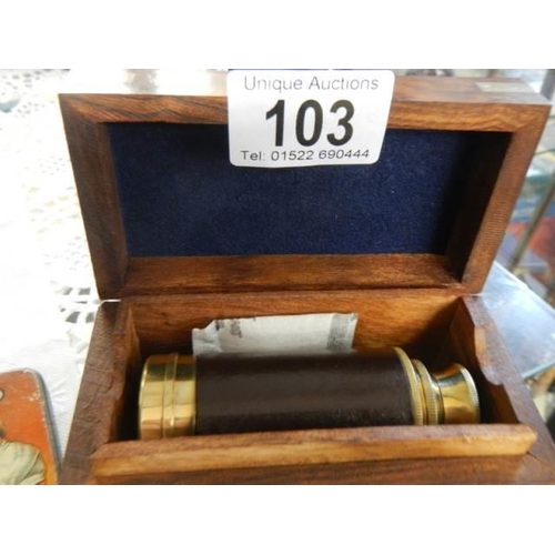 103 - A brass telescope in a wooden box.