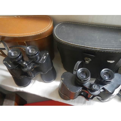 123 - Two cased pairs of binoculars.