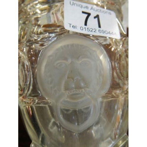 71 - A glass celery vase with lions head decoration.