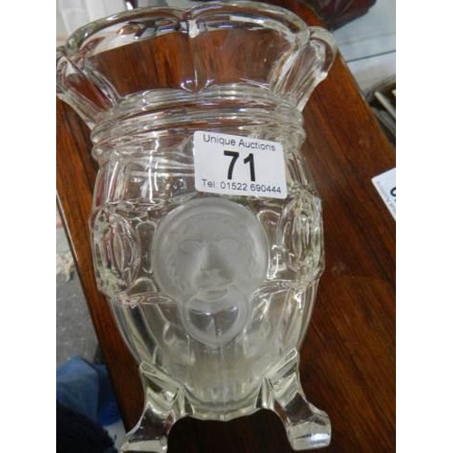 71 - A glass celery vase with lions head decoration.