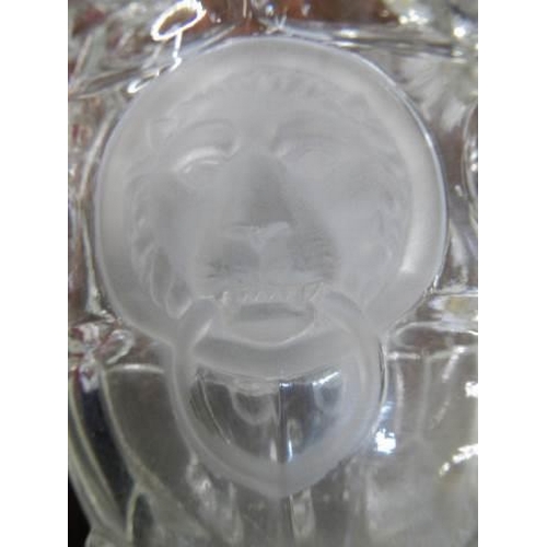 71 - A glass celery vase with lions head decoration.