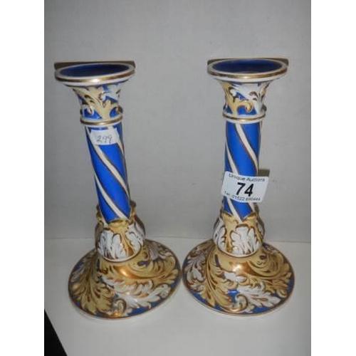 74 - A pair of continental porcelain candlesticks.