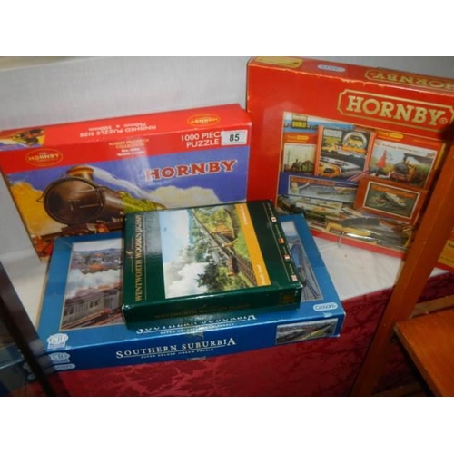 85 - Four railway related jigsaw puzzles including two Hornby.