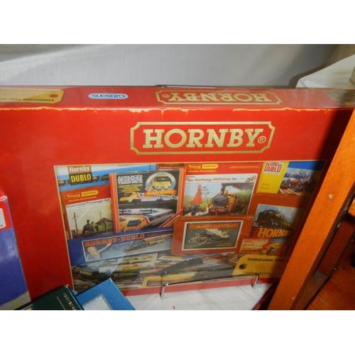 85 - Four railway related jigsaw puzzles including two Hornby.