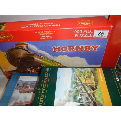 85 - Four railway related jigsaw puzzles including two Hornby.