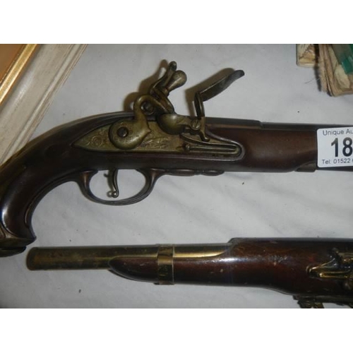 184 - A pair of Flintlock pistol wall pieces.