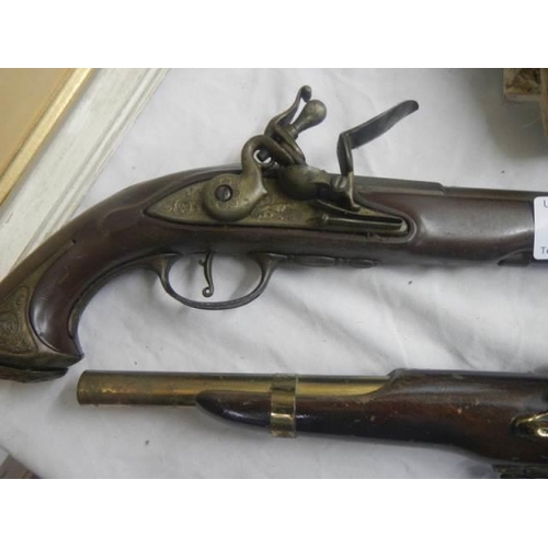 184 - A pair of Flintlock pistol wall pieces.