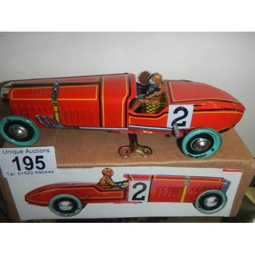 195 - A boxed tin plate racing car.