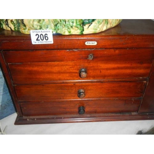 206 - A small mahogany three drawer chest,.