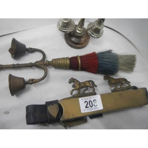 208 - A brass horse bell and other horse related items.