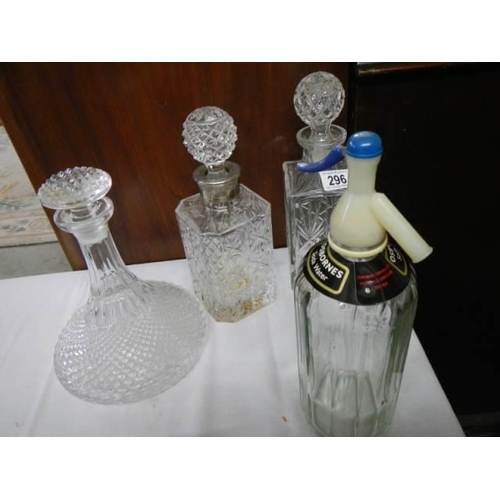 296 - Three decanters and a soda syphon, COLLECT ONLY.