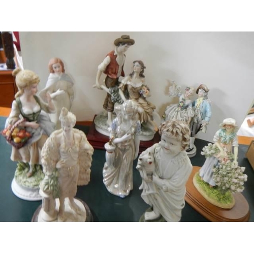 297 - A quantity of porcelain figures.