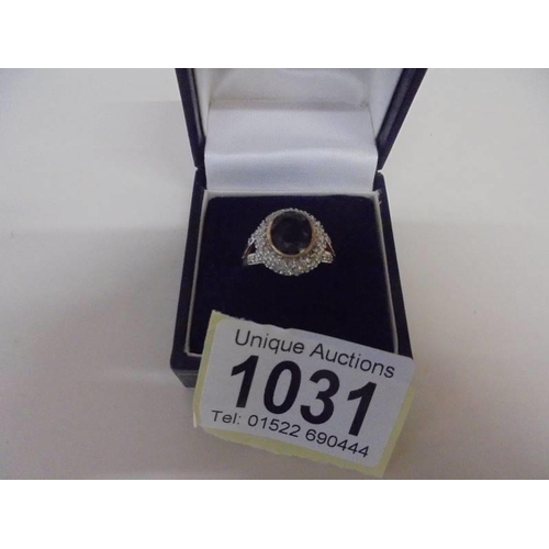 1031 - A large oval sapphire and diamond ring, size O half, 4.9 grams.