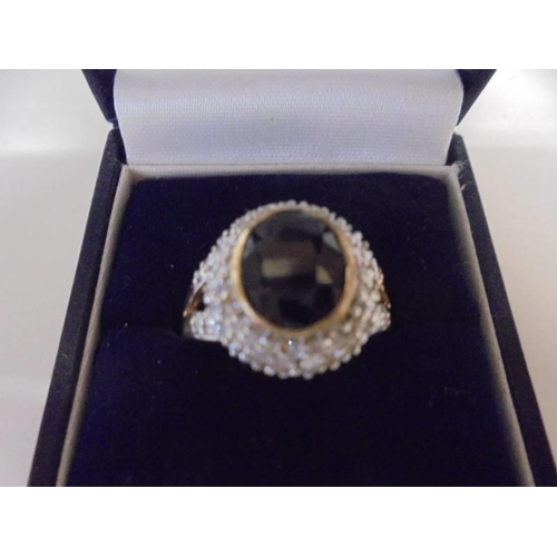 1031 - A large oval sapphire and diamond ring, size O half, 4.9 grams.