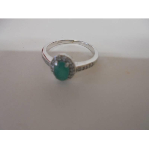 1034 - An oval top quality emerald and diamond ring set in yellow gold, size K half, 2.1 grams.