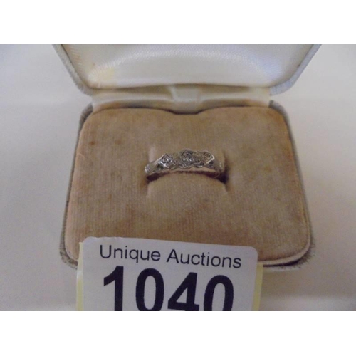 1040 - An 18ct gold three stone diamond ring, size K, 2 grams/