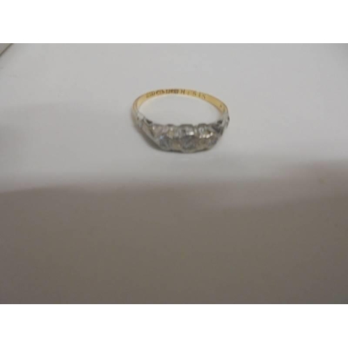 1040 - An 18ct gold three stone diamond ring, size K, 2 grams/