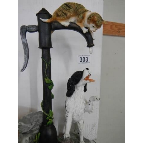 303 - A good figure of a cat and dog on a water pump.