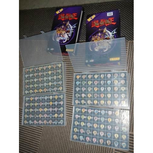 312 - Two empty Panina YU-GI-OH collector's albums with 4 plastic containers