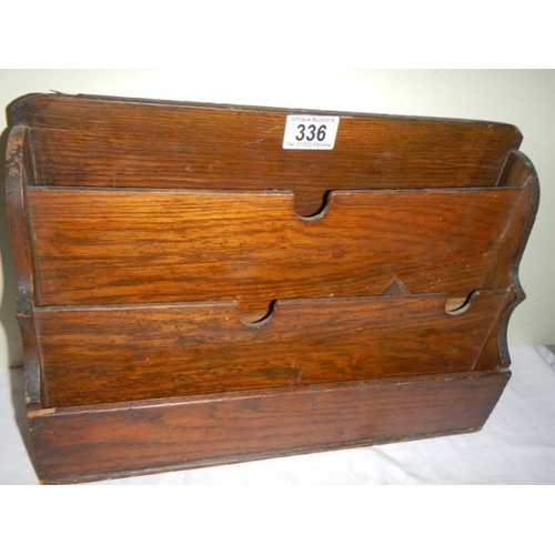 336 - An oak letter rack.