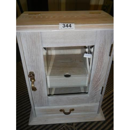 344 - A good quality limed oak smokers cabinet.