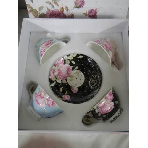 345 - A boxed set of four porcelain tea cups and saucers.