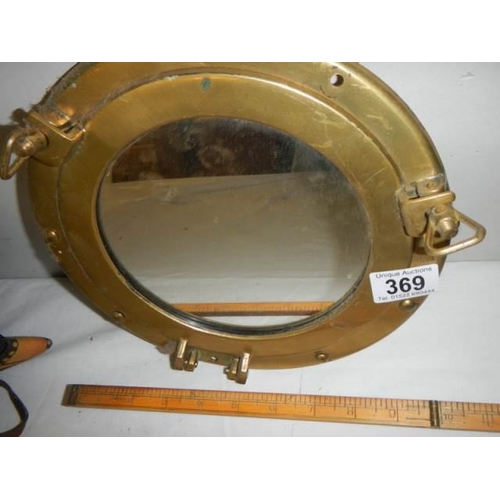 369 - A brass ship's porthole mirror.