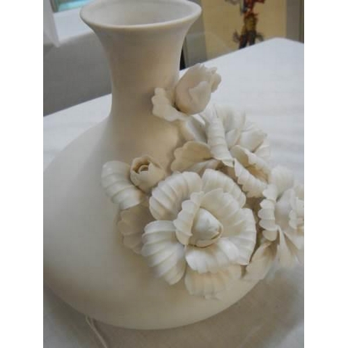 386 - A white floral decorated vase.