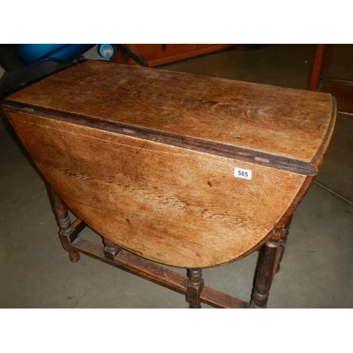 585 - An oak gateleg table, COLLECT ONLY.