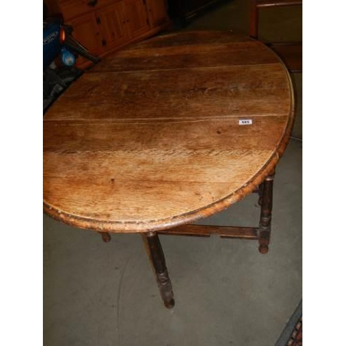 585 - An oak gateleg table, COLLECT ONLY.