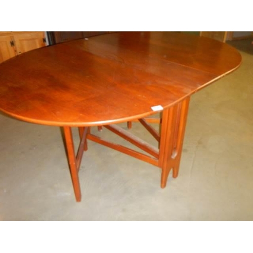 598 - An oval teak drop leaf table, COLLECT ONLY.