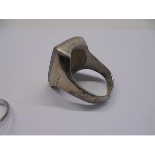 1001 - Two white metal dress rings and another white metal ring featuring a Roman head (a/f).