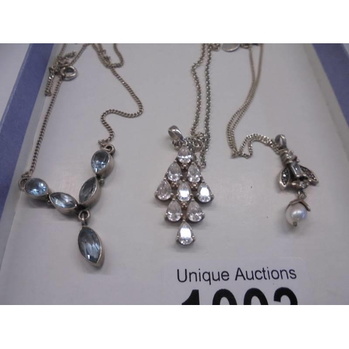 1003 - Three silver pendants.