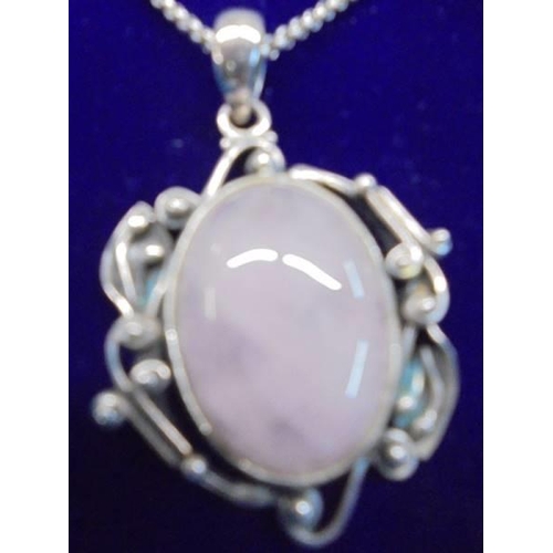 1004 - An art nouveau style silver pendant on a silver chain.