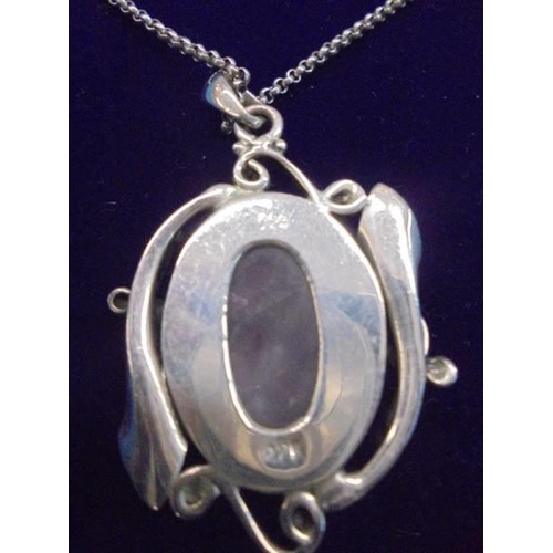 1004 - An art nouveau style silver pendant on a silver chain.