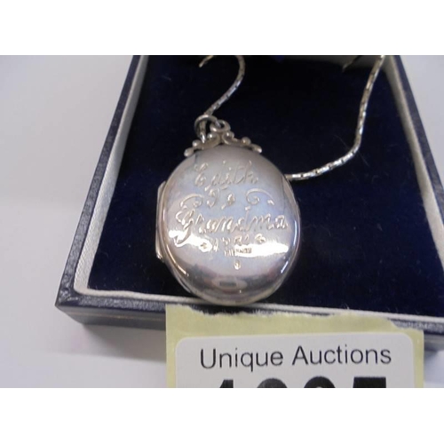 1005 - A silver locket on a silver chain,