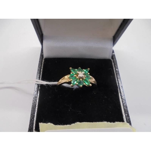 1012 - A 9ct gold diamond and green stone ring, size R, 2.1 grams.