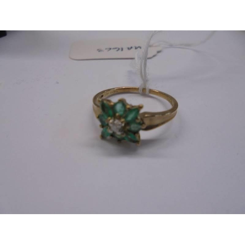 1012 - A 9ct gold diamond and green stone ring, size R, 2.1 grams.