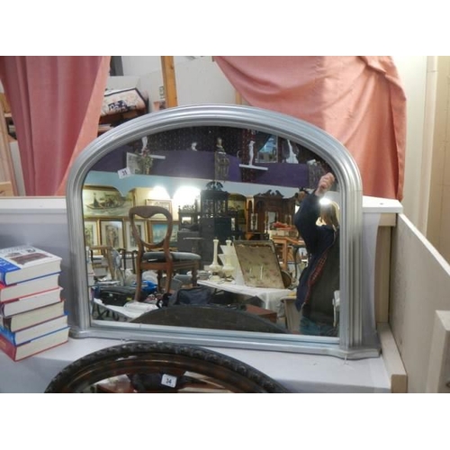 35 - An arched mirror in silver coloured frame, COLLECT ONLY.