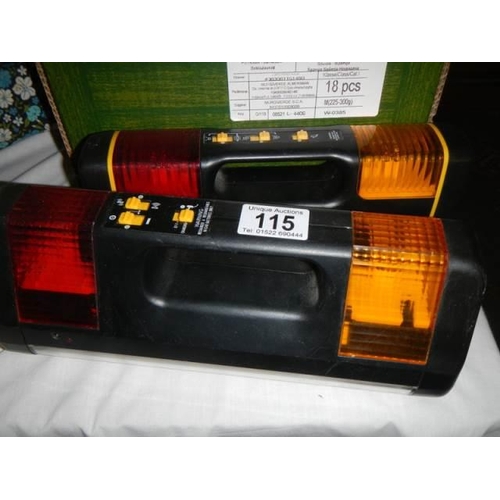 115 - Two battery emergency lights.