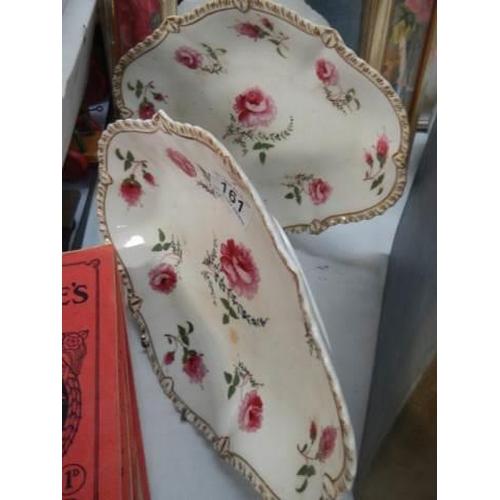 161 - A pair of rose decorated dishes.