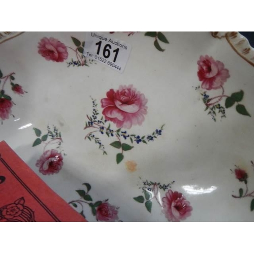 161 - A pair of rose decorated dishes.