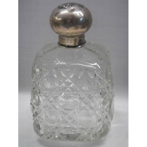 1047 - A hobnail cut glass bottle with silver top embosses with two heads.