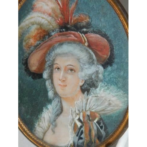 1051 - A miniature brass framed painting of a Victorian lady,