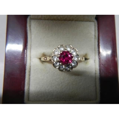 1072 - A red and white stone set ring. 9ct.