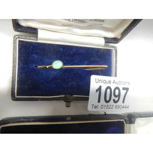 1097 - Two 9ct gold brooches on being set an opal, 3.55 grams.