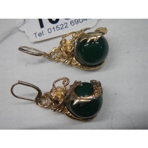 1091 - A good pair of yellow metal earrings with onyx ball in centres.