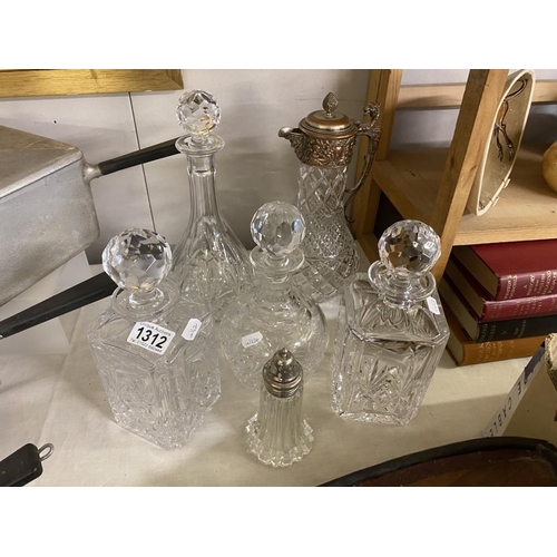 A good selection of crystal decanters, silver plate topped carafe and sugar sifter