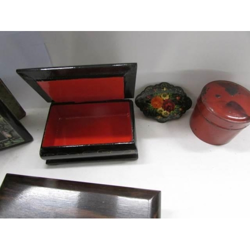 1165 - A Russian Lacquered snuff box, three other boxes and a lacquered blotter.