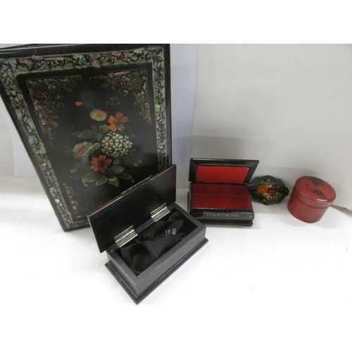 1165 - A Russian Lacquered snuff box, three other boxes and a lacquered blotter.